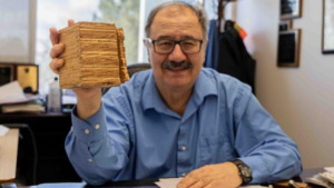 Chris Pantelides in his office with a piece of mass timber.